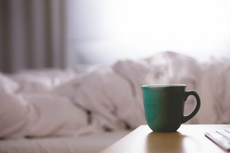 Background of bedding and cup of coffee